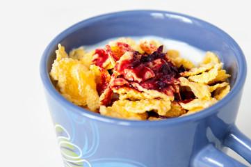 Mug with milk drinks, cereal and jam
