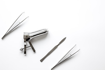 instruments of gynecologist on white background top view