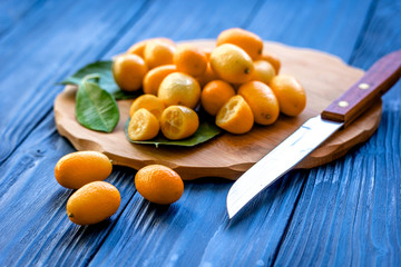 kumquat on plate at wooden table
