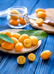 kumquat on plate at wooden table