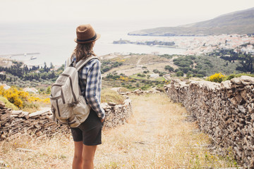 Hiker traveler woman on a hiking trail, travel and active lifestyle concept