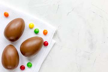 Easter chocolate eggs top view on stone background mock up