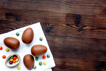Easter chocolate eggs top view on wooden background mock up