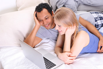 Young couple watching movie on laptop