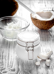 organic cosmetics with coconut on wooden background close up