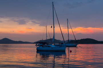 Fototapeta na wymiar moored sailboats after the sunset, Kornati, Croatia