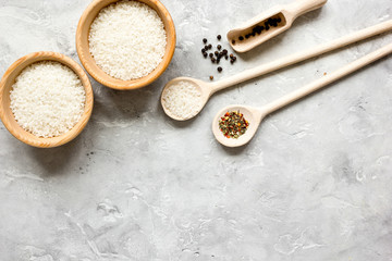 Obraz na płótnie Canvas rice for paella on stone background top view mock up