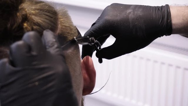 Men's hairstyling and haircutting in a barber shop or hair salon.