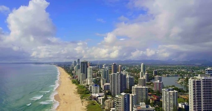 Aerial over ocean surf into the beach of Surfers Paradise Gold Coast