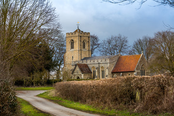 Fototapeta premium Landscape image St.Michael & All Angels Church, Abington Pigotts, a classic British winter scene Cambridgeshire, UK