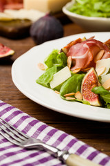 Fresh salad with figs and prosciutto.