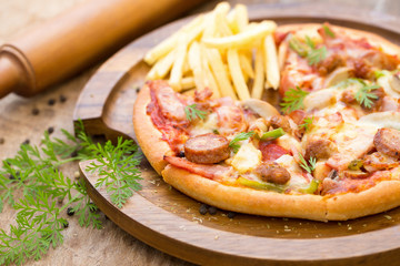 ham, mushroom and olive pizza, Top view of pizza on rustic table