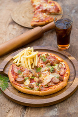 ham, mushroom and olive pizza, Top view of pizza on rustic table