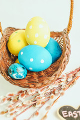 colorful easter eggs in a basket on white background