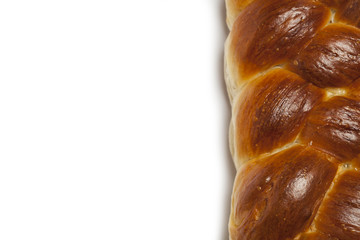 Freshly baked homemade challah bread on white background, with copy space