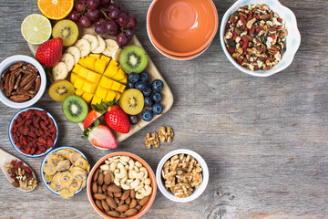 Healthy and various morning breakfast selection, paleo style:  oat free gluten free cereals, nuts, fruits, berries, selective focus. Top view