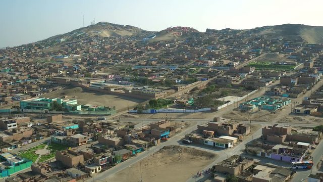 Ventanilla Peru Aerial v6 Flying low over urban poverty hillside housing area.