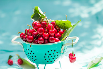 fresh red cherry fruit green colander