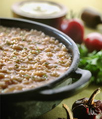 Soupy rice in earthenware casserole