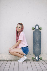 cool teen model with pink braids in a skate park