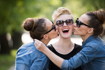 Fototapeta premium portrait of three young beautiful woman with sunglasses