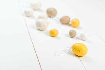 Easter card. Scattered pastel Easter eggs on a wooden background.