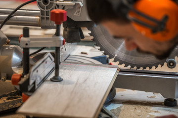 a man working with electric saw