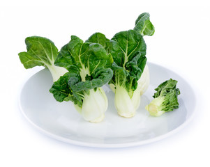 Baby vegetables Choy on white plate isolated on white background