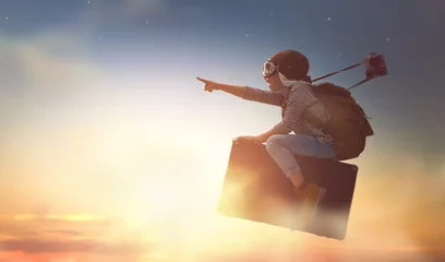 Foto op Plexiglas Child flying on a suitcase © Konstantin Yuganov