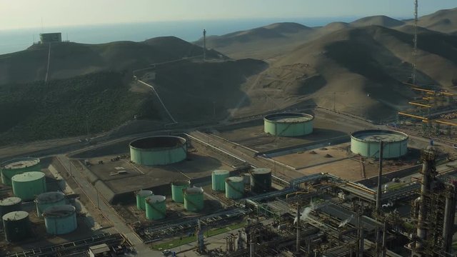 Ventanilla Peru Aerial v14 Flying low over oil refinery panning over and down.