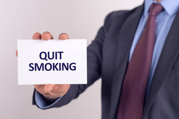 Man showing paper with QUIT SMOKING text