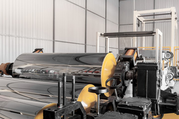 polypropylene and polyethylene are moving the shaft and roller closeup. cellophane and polypropylene on the moving in shafts