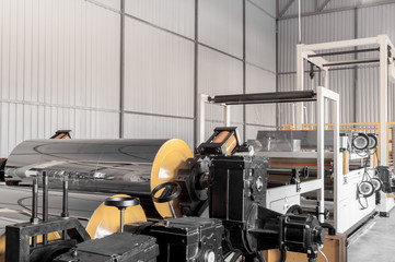 Fototapeta premium polypropylene and polyethylene are moving the shaft and roller closeup. cellophane and polypropylene on the moving in shafts