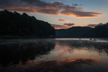 Fototapeta na wymiar Sunrise at Pang Ung Lake in Mae Hong Son's city, North of THAILAND.