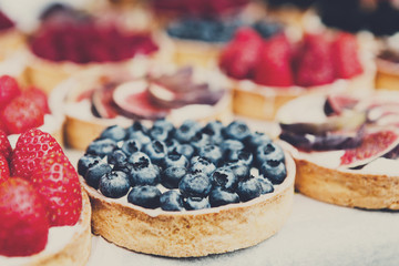 Fruit and berry tarts dessert tray assorted outdoors