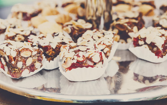 Caramel and nuts candies, cookies and biscuits on banquet table.