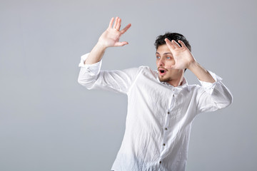 handsome young man in  white shirt dancing and having fun on gre