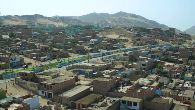 Ventanilla Peru Aerial v25 Flying low over urban poverty hillside housing area.