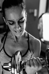 Woman exercising with weights in the gym