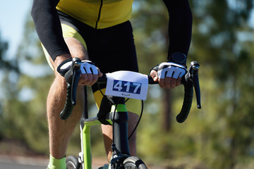Cyclist in the race on a road bike handlebar detail