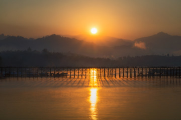 Sunrise time over the old wooded bridge over the river (Mon Bridge) in Sangkhlaburi District; Kanchanaburi; Thailand.