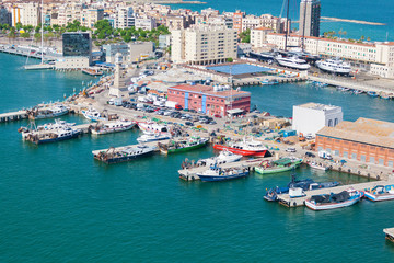 Fototapeta na wymiar Port of Barcelona. Fishing boats scattered on the dock fishing nets