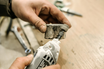 Carpenter using electric hand grinder