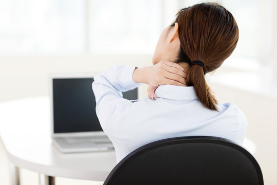 Young Business Woman With Neck Ache In Office