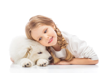 Little girl with a samoyed puppy