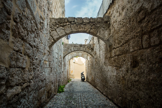 Fototapeta Medieval arched street in the old town of Rhodes, Greece