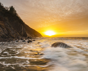 Fototapeta na wymiar a spectacular, dynamic sunset around the cliffs in Wolin national park in Poland