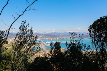 Panorama with a harbour, houses, sea and mountains