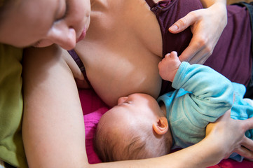 Mother breastfeeding a newborn baby boy