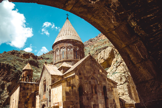 Entry through arch to cave monastery Geghard, Armenia. Armenian architecture. Pilgrimage place. Religion background. Travel concept. Church Astvatsatsin. Tourism industry